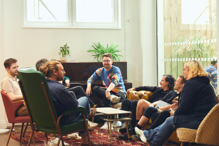 A group of people smiling and laughing in a circle