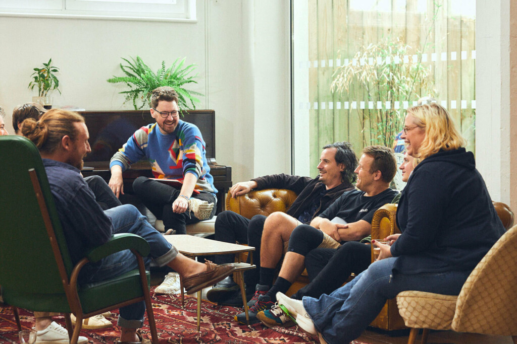 A group of people talking and laughing in a circle