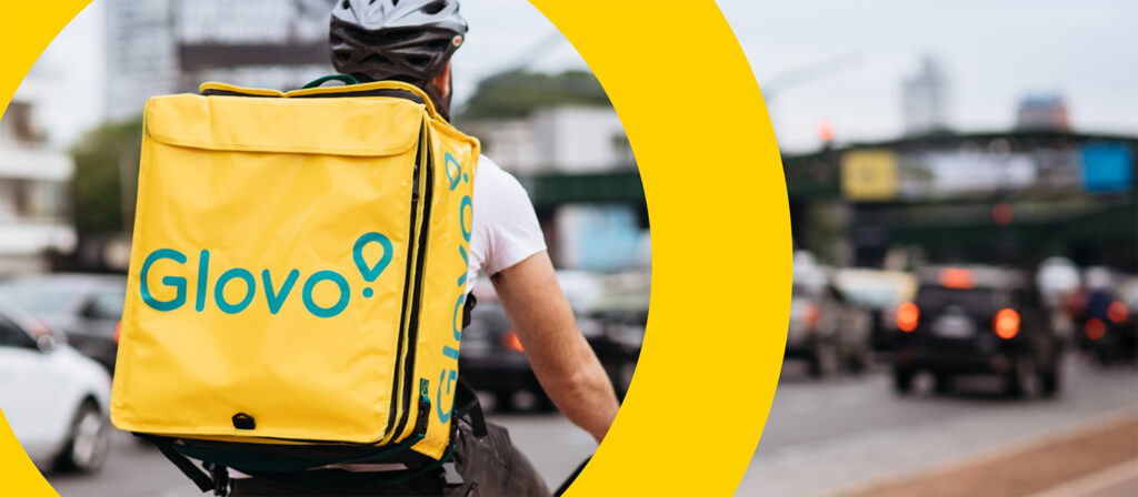 Glovo delivery rider cycling through city
